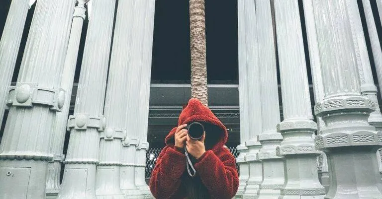 A Photographer Capturing The Iconic Urban Light Sculpture At Lacma In Los Angeles, Illuminated At Night.