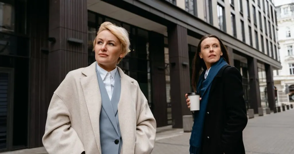 Two women in stylish professional attire walking in a modern urban environment.