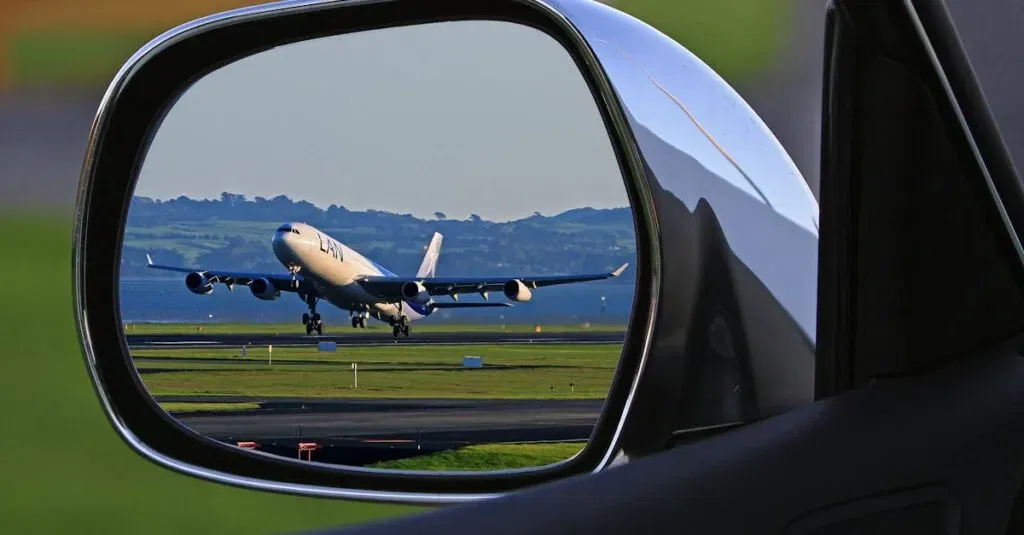 Car Rental At Laguardia Airport: Your Guide To A Smooth Ride With Jetblack 1 April 4, 2026 A Jet Airplane Taking Off Is Reflected In A Car'S Side Mirror, Capturing A Unique Aviation Perspective.