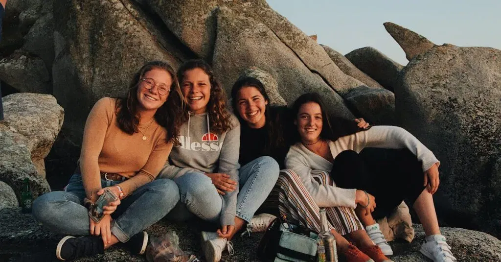 Cab Fare From Lga To Manhattan: Costs, Tips &Amp; Best Travel Options 6 April 4, 2026 Group Of Cheerful Young Female Friends In Casual Clothes Laughing And Looking At Camera While Sitting With Drinks And Snacks On Rocky Seashore And Having Fun During Travel Together