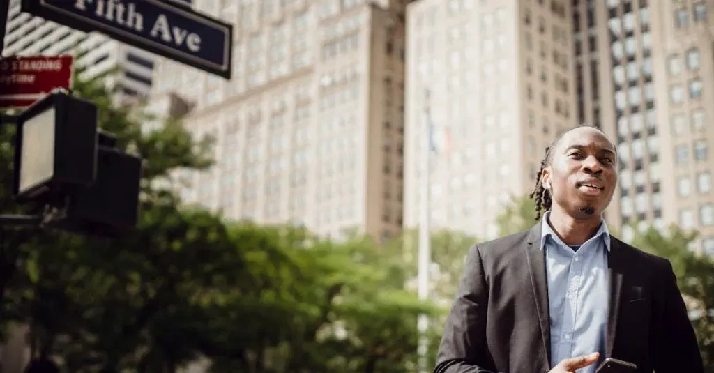 A Young Man Stands On Fifth Avenue In New York City Holding A Smartphone, Showcasing Urban Lifestyle.