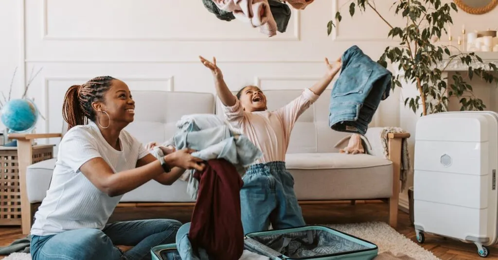 Mother and daughter joyfully packing clothes into a suitcase for a family trip.