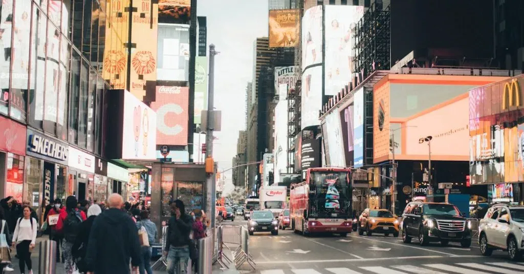 Buses To Jfk From Manhattan – Everything You Need To Know As A Traveler 7 April 4, 2026 Busy Times Square In Nyc, Bustling With People, Billboards, And Traffic.