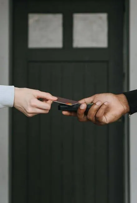 Close-Up Of Hands Exchanging Credit Card For Contactless Payment, Emphasizing Cashless Transactions.