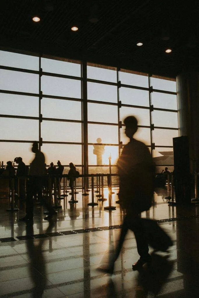 How A Private Car To Airport Makes Nyc Travel Less Of A Nightmare: A Road-Weary Traveler’s Ramblings 5 February 1, 2026 Passengers Silhouetted Against Sunrise In An Airport Terminal, Capturing The Essence Of Travel.