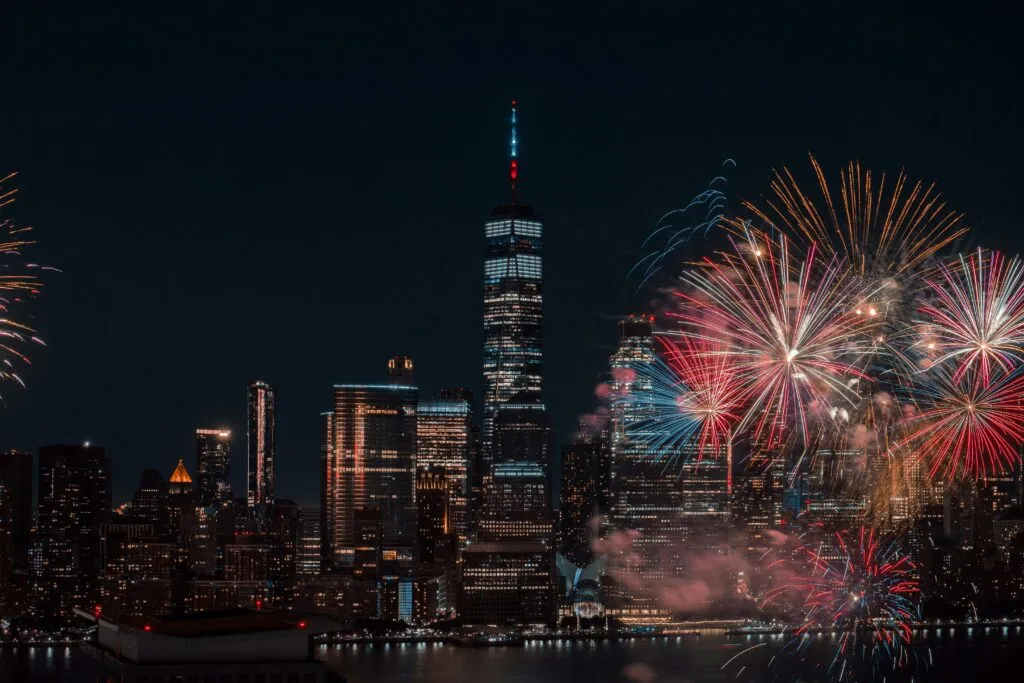 Colorful Fireworks Illuminating The New York City Skyline At Night, Capturing A Vibrant Celebration.