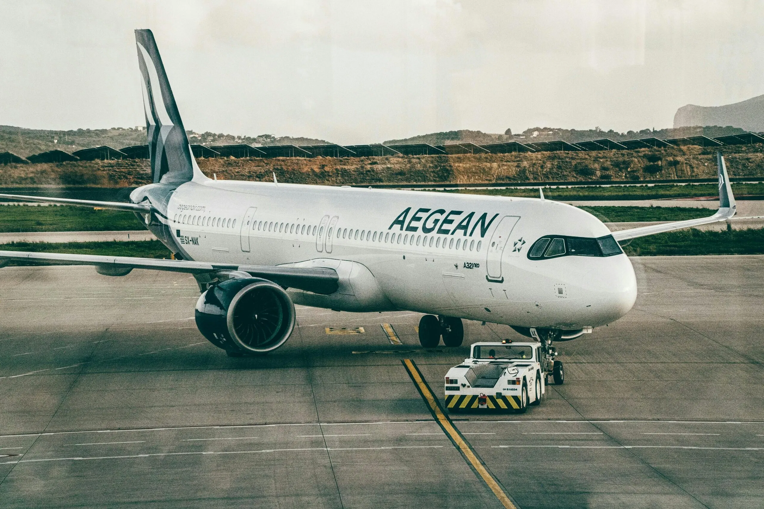 Aegean Airlines Aircraft Being Towed At An Airport, Ready For Takeoff.