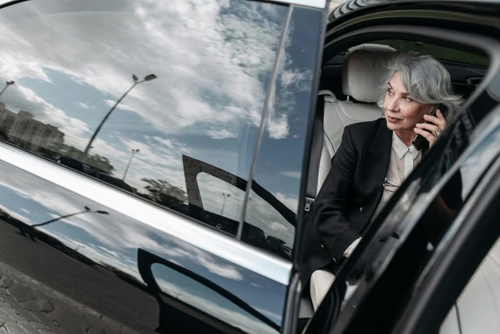 eco friendly car service NYC to JFK hybrid SUV at JFK airport arrivals terminal